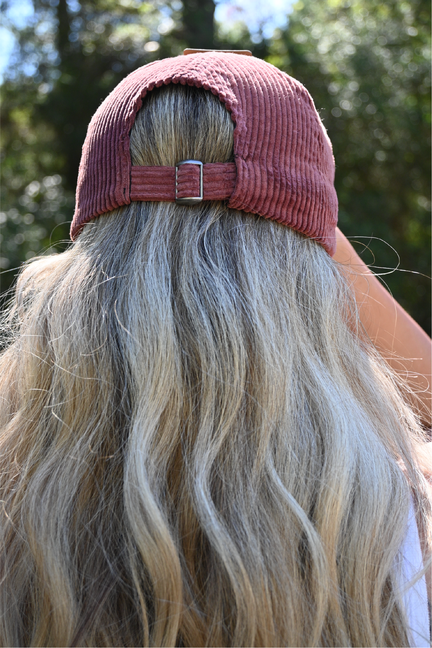 The back of a burgundy corduroy dog mom hat.
