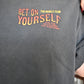 Black graphic tee with 'Bet On Yourself' text on a person wearing it.