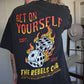 Person wearing a black t-shirt with a graphic design and text.