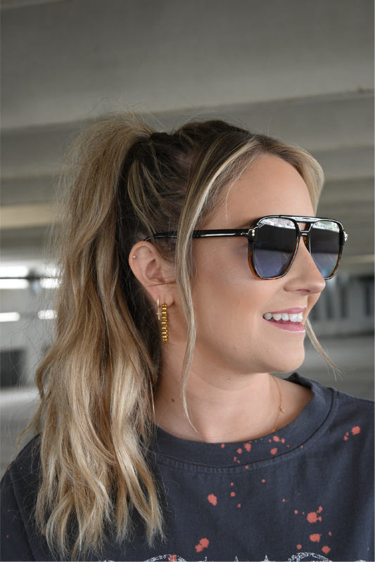 Model is showing the side of the black to cheetah ombre sunglasses.