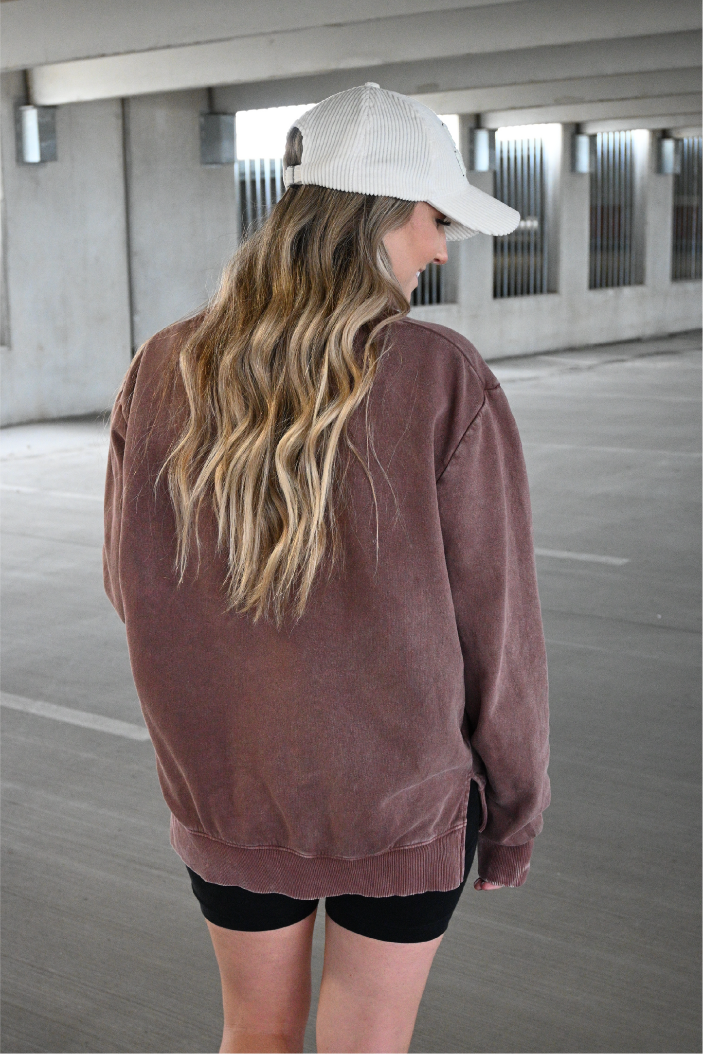 Up close image of the back of the relaxed fit brown crewneck.