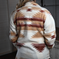 Back view of a southwest style oversized jacket being worn by a woman.