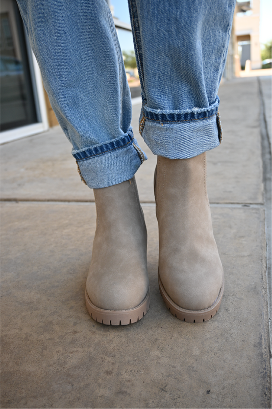 a front view of the sahara slip on booties paired with the 90's high rise jeans cuffed