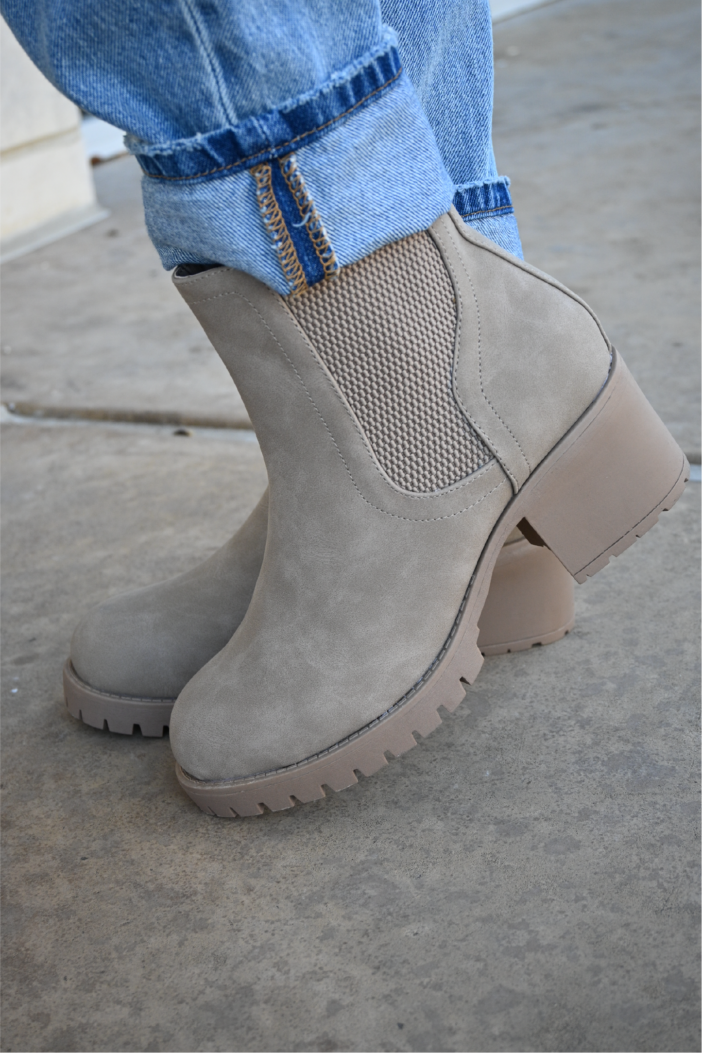 a side view of the sahara slip on booties paired with the 90's high rise jeans